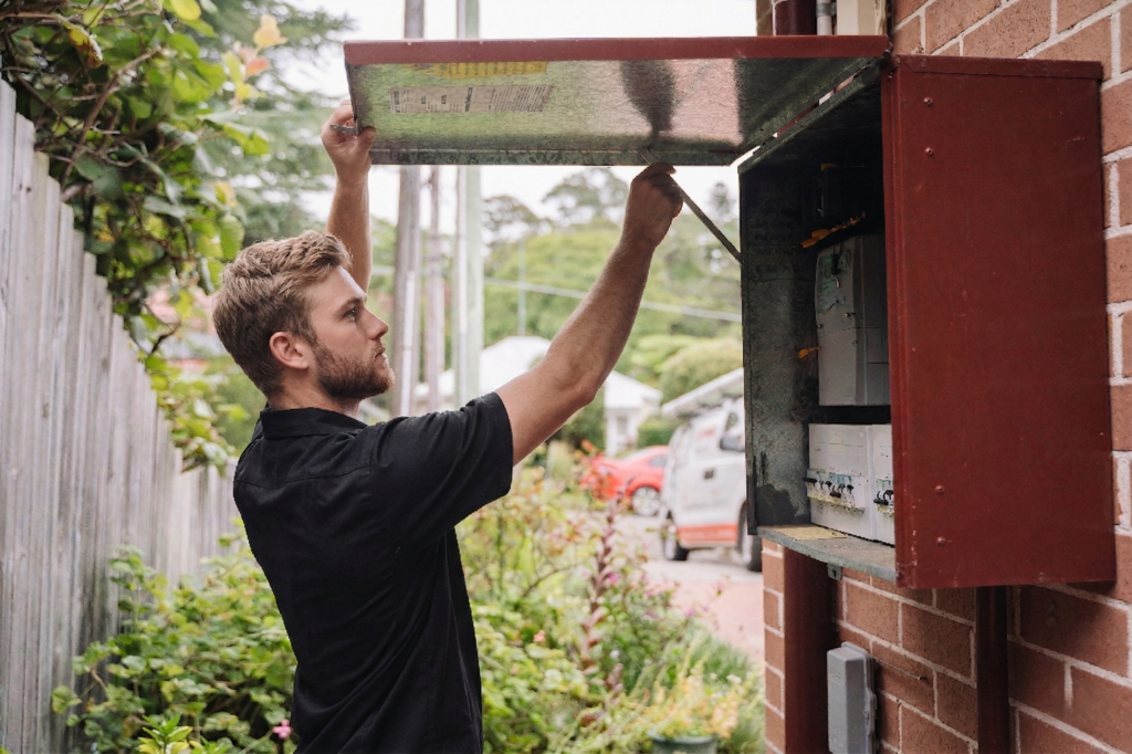 Electrician installing downlights in a Potts Point home